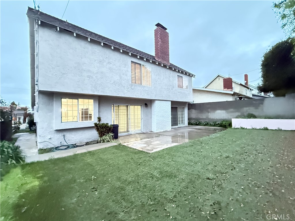 19312 Gunlock Avenue Carson, CA 90746 - Photo 38 of 44 a front view of a house with a yard and outdoor seating