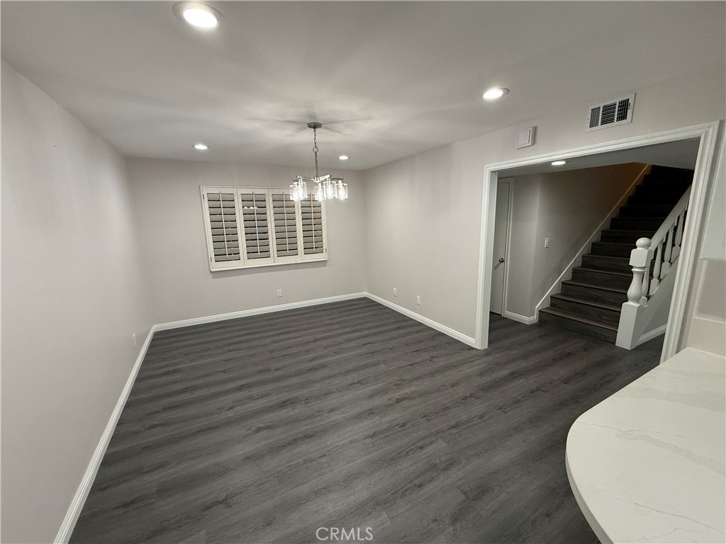19312 Gunlock Avenue Carson, CA 90746 - Photo 7 of 44 a view of an empty room with wooden floor and a window