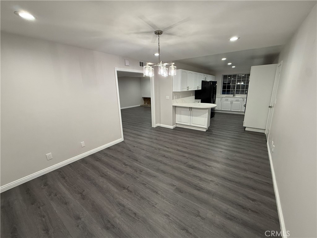 19312 Gunlock Avenue Carson, CA 90746 - Photo 8 of 44 a view of a kitchen with cabinets and wooden floor