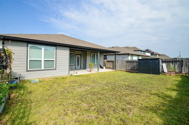 a view of a house with a yard and sitting area