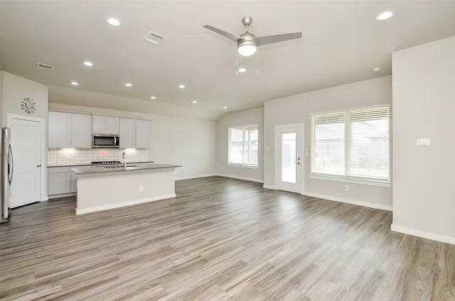 a view of kitchen with refrigerator and window