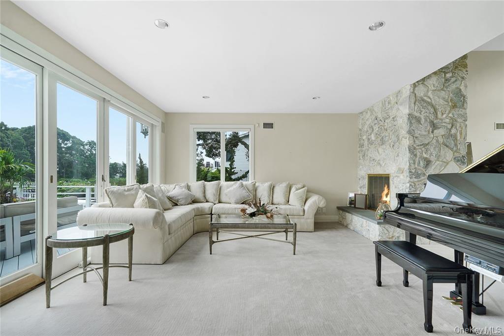 4 Mill Pond Road Hampton Bays, NY 11946 - Photo 12 of 24 a living room with furniture and a large window