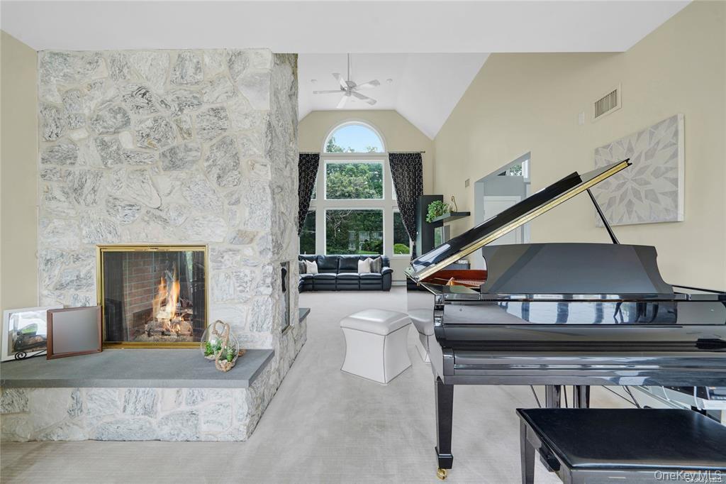 4 Mill Pond Road Hampton Bays, NY 11946 - Photo 13 of 24 a living room with furniture a fireplace and a potted plant