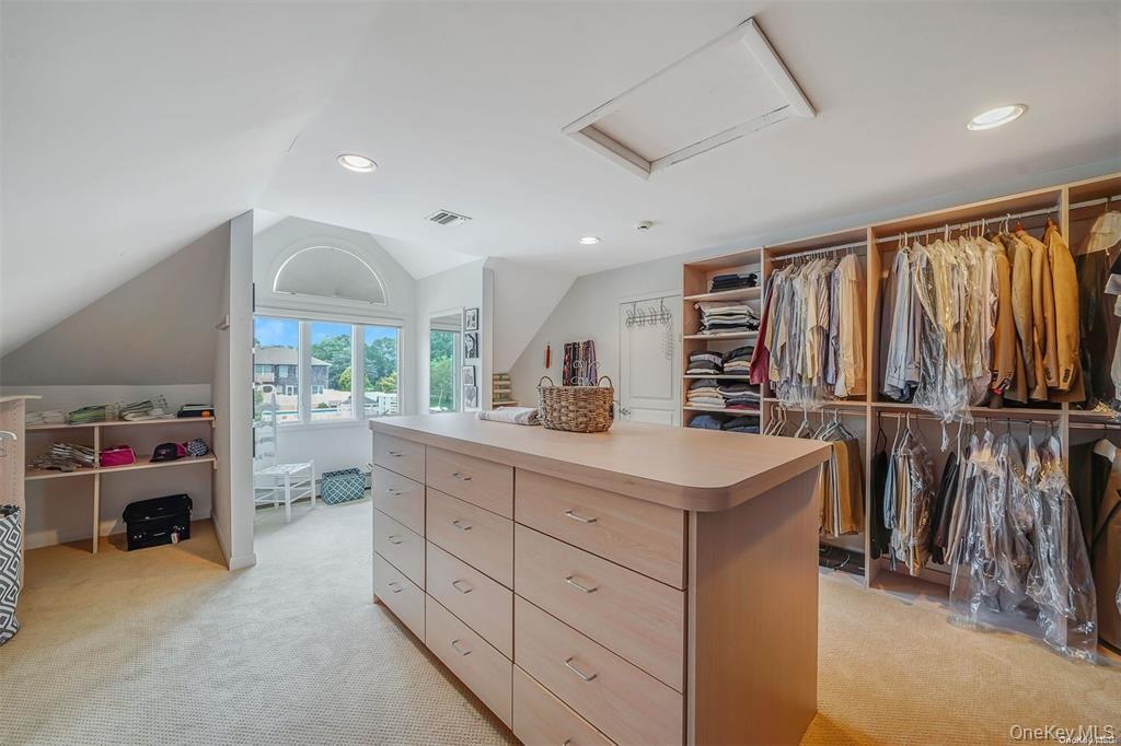 4 Mill Pond Road Hampton Bays, NY 11946 - Photo 15 of 24 a kitchen with cabinets and outdoor view