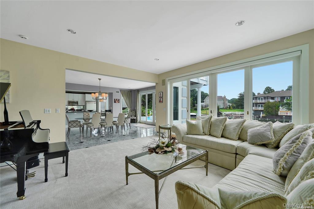 4 Mill Pond Road Hampton Bays, NY 11946 - Photo 16 of 24 a living room with furniture and a large window