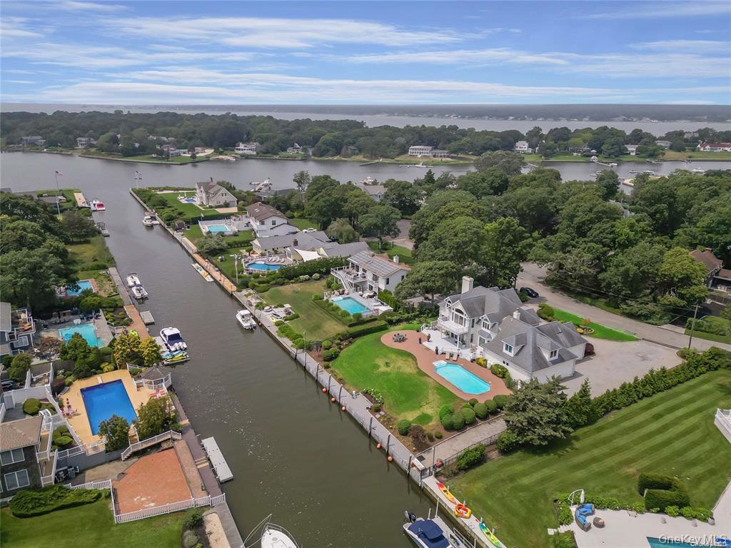 4 Mill Pond Road Hampton Bays, NY 11946 - Photo 3 of 24 an aerial view of a city with a lake