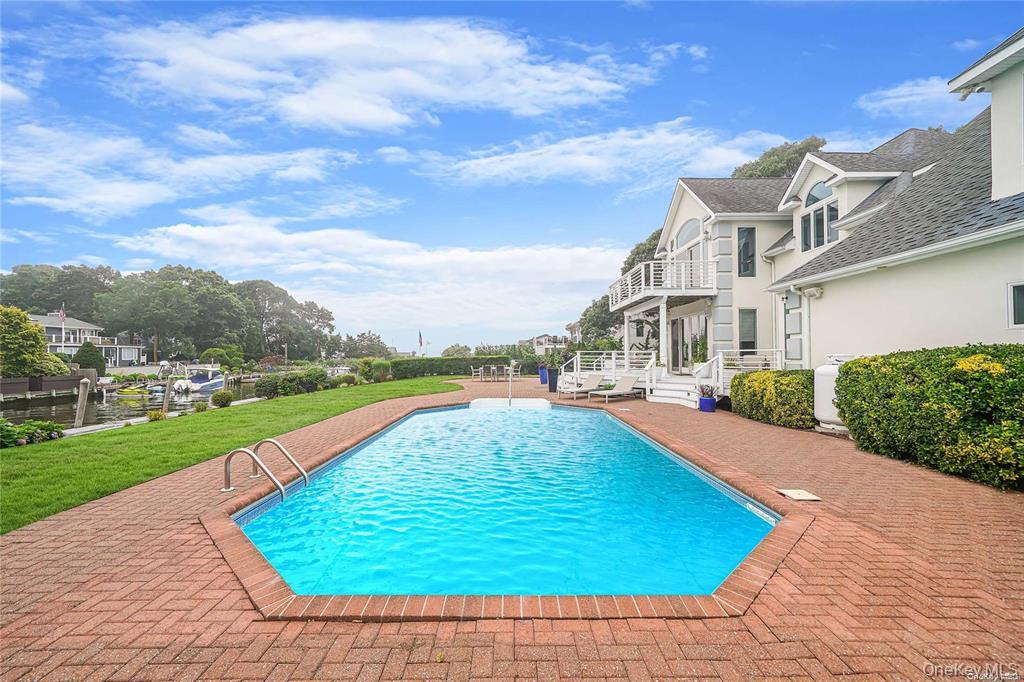 4 Mill Pond Road Hampton Bays, NY 11946 - Photo 6 of 24 a view of a house with a yard