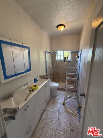 a bathroom with a tub sink and mirror