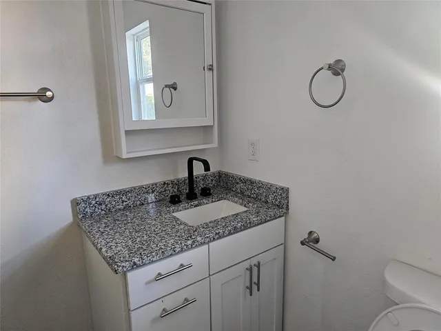 a kitchen with sink microwave refrigerator and stove