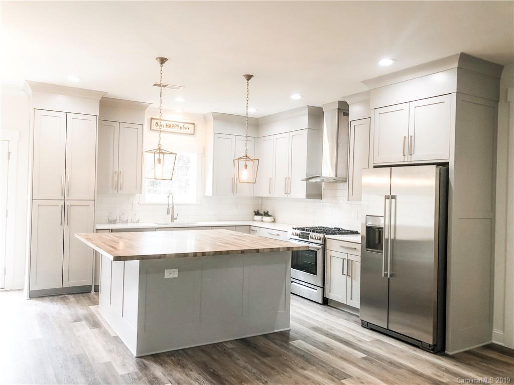 7825 Chestnut Ridge Drive Charlotte, NC 28215 - Photo 12 of 44 a kitchen with stainless steel appliances granite countertop a sink stove and refrigerator
