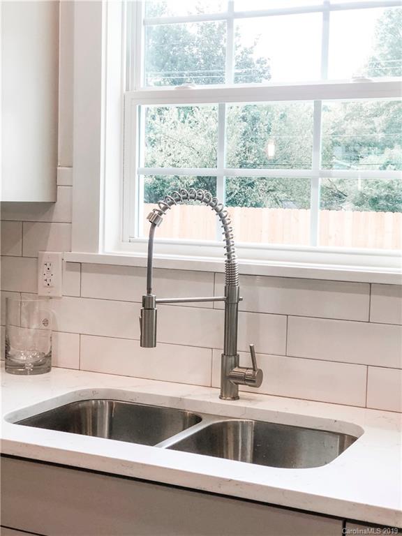 7825 Chestnut Ridge Drive Charlotte, NC 28215 - Photo 16 of 44 a kitchen sink sitting next to a window