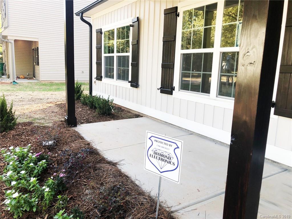 7825 Chestnut Ridge Drive Charlotte, NC 28215 - Photo 3 of 44 a front view of a house with a yard