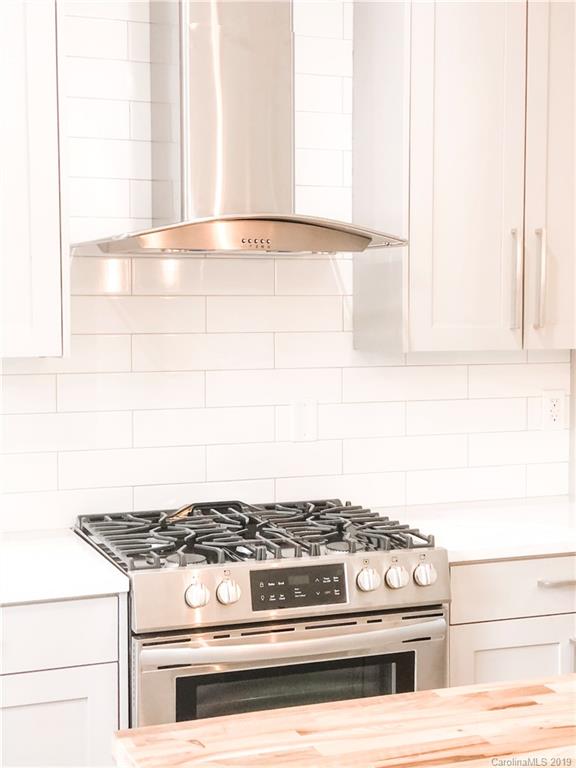 7825 Chestnut Ridge Drive Charlotte, NC 28215 - Photo 21 of 44 a stove top oven sitting inside of a kitchen