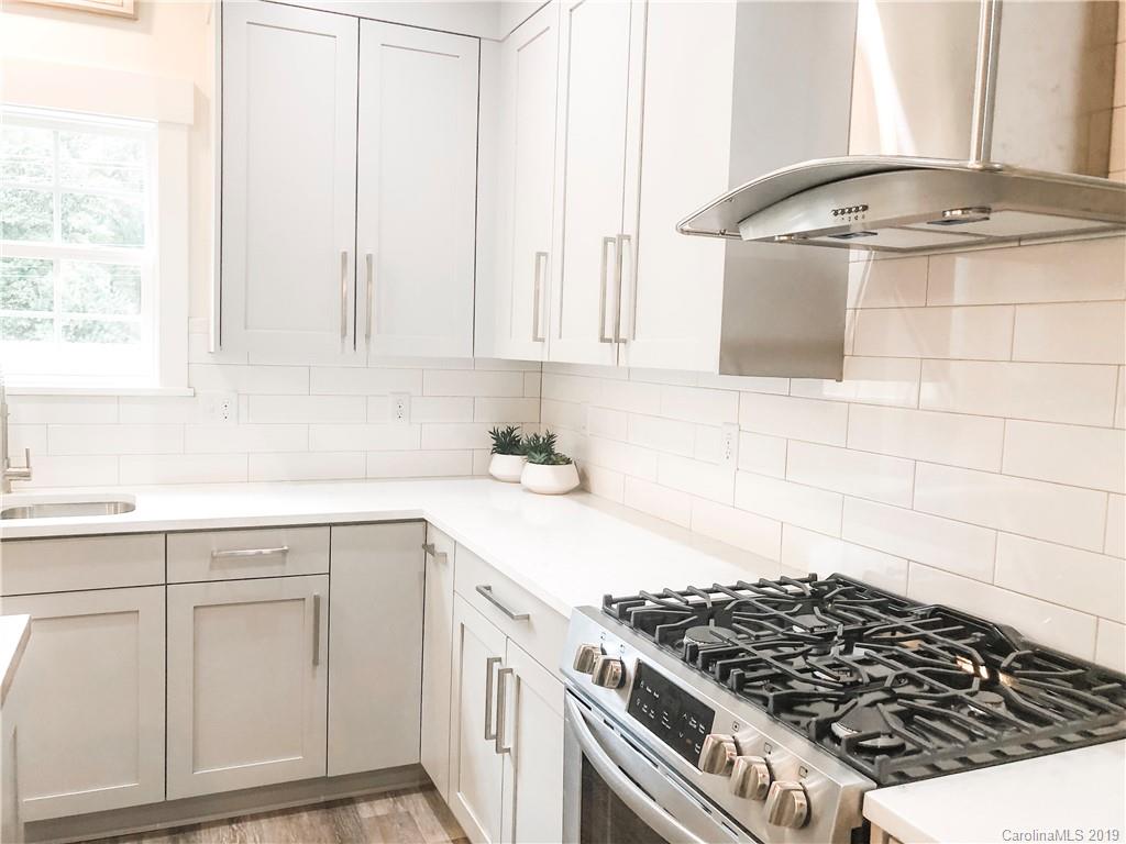7825 Chestnut Ridge Drive Charlotte, NC 28215 - Photo 22 of 44 a kitchen with white cabinets and appliances