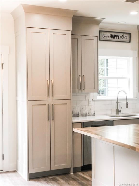 7825 Chestnut Ridge Drive Charlotte, NC 28215 - Photo 25 of 44 a kitchen with a sink and a refrigerator