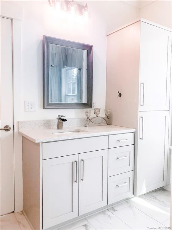 7825 Chestnut Ridge Drive Charlotte, NC 28215 - Photo 31 of 44 a bathroom with a sink vanity and a mirror