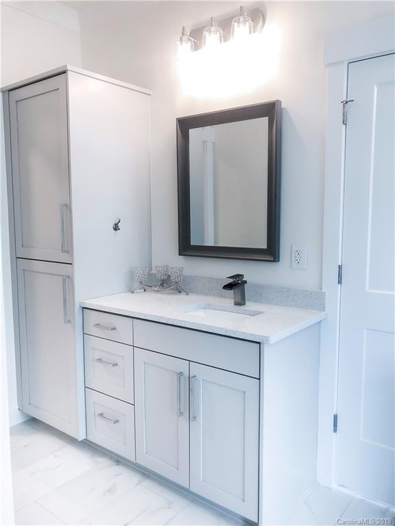 7825 Chestnut Ridge Drive Charlotte, NC 28215 - Photo 32 of 44 a bathroom with a double vanity sink and a mirror