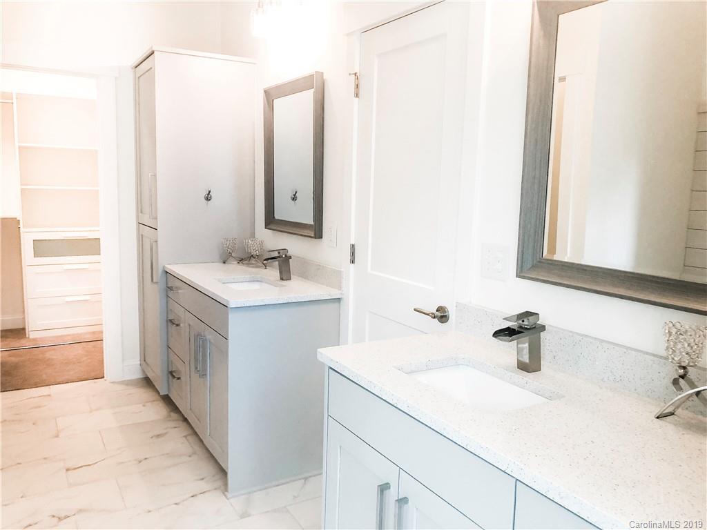 7825 Chestnut Ridge Drive Charlotte, NC 28215 - Photo 33 of 44 a bathroom with a sink and a mirror