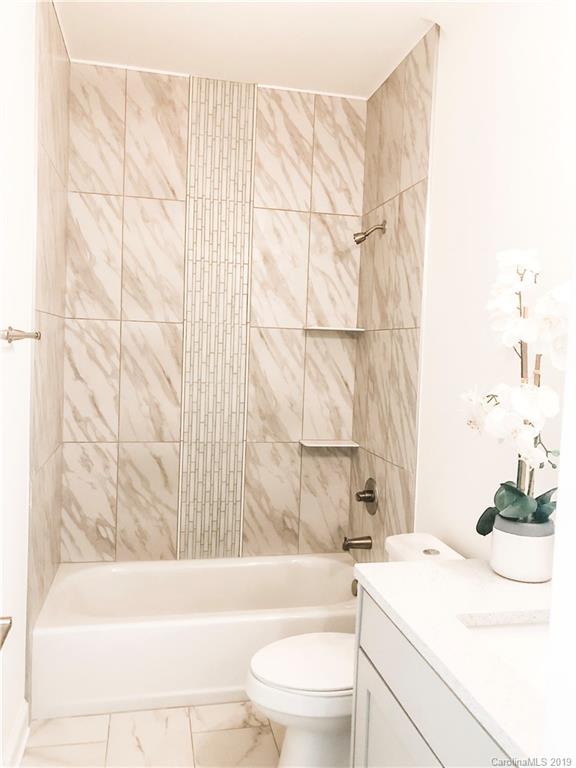 7825 Chestnut Ridge Drive Charlotte, NC 28215 - Photo 38 of 44 a bathroom with a sink a toilet and a bathtub