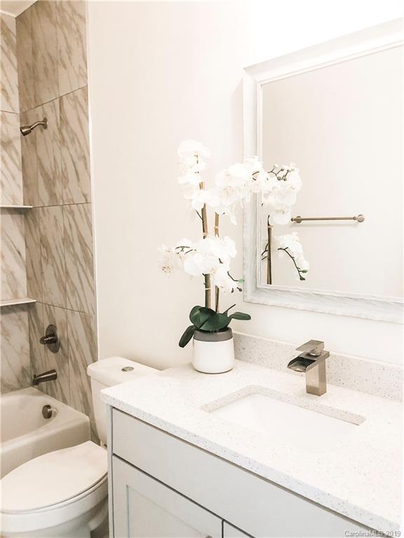 7825 Chestnut Ridge Drive Charlotte, NC 28215 - Photo 39 of 44 a bathroom with a sink vanity mirror and toilet