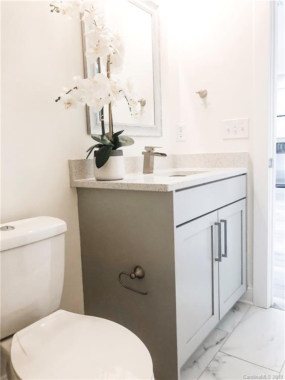 7825 Chestnut Ridge Drive Charlotte, NC 28215 - Photo 40 of 44 a bathroom with a sink toilet and mirror