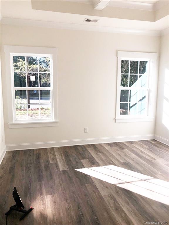 7825 Chestnut Ridge Drive Charlotte, NC 28215 - Photo 41 of 44 an empty room with wooden floor and windows