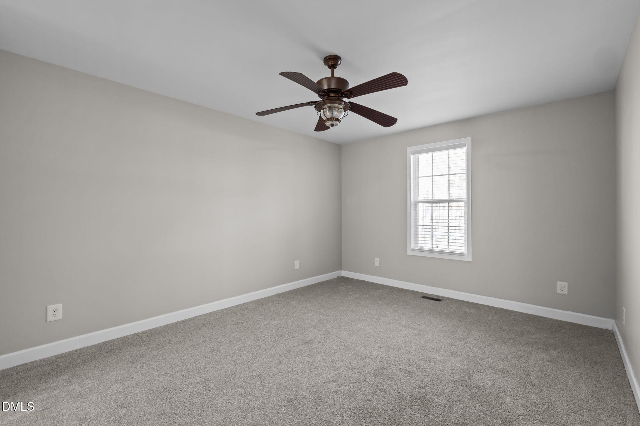 144 Kiser Hicks Road Roxboro, NC 27574 - Photo 16 of 38 an empty room with a window and a fan