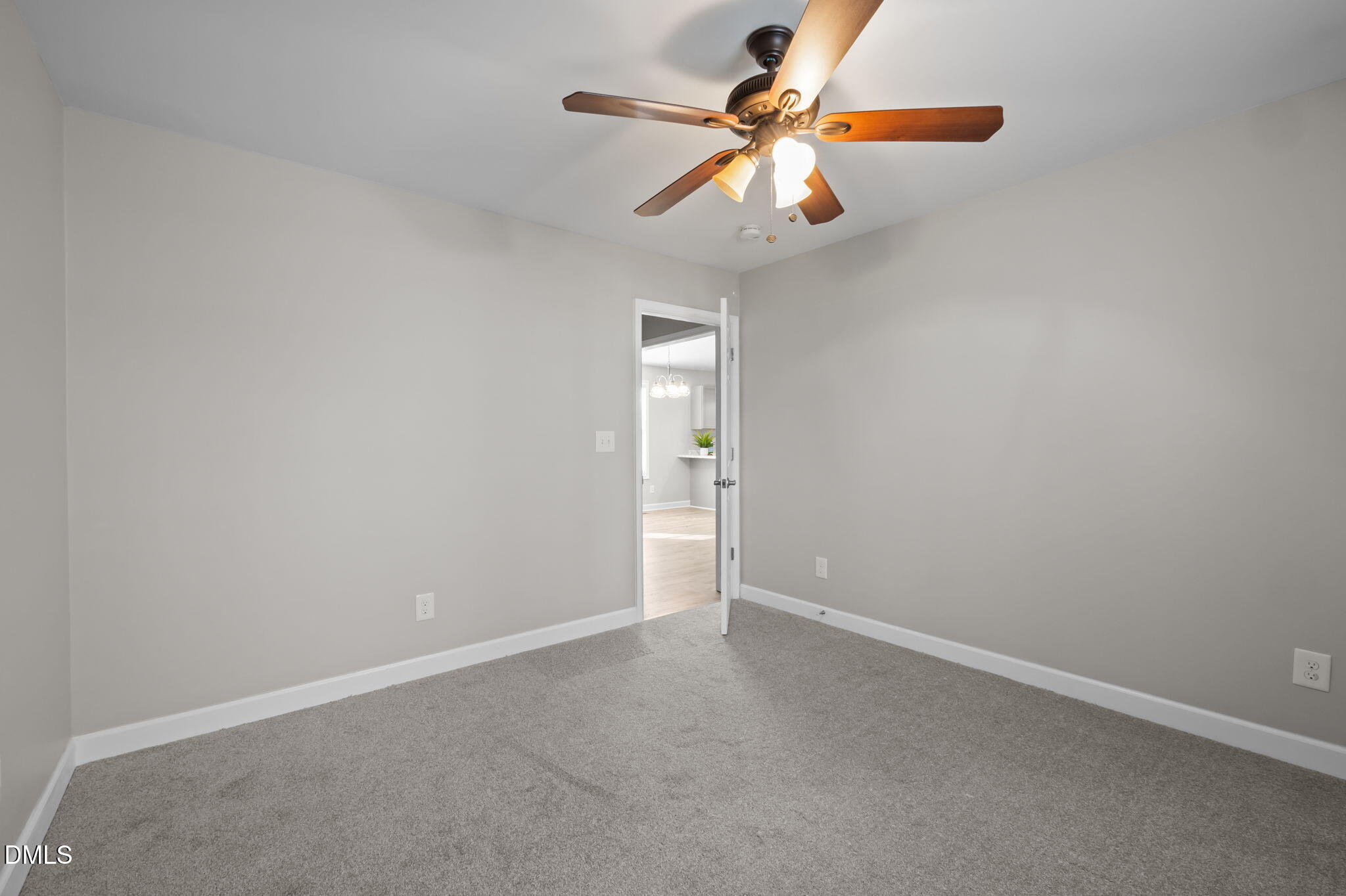 144 Kiser Hicks Road Roxboro, NC 27574 - Photo 19 of 38 an empty room with a chandelier fan and a window