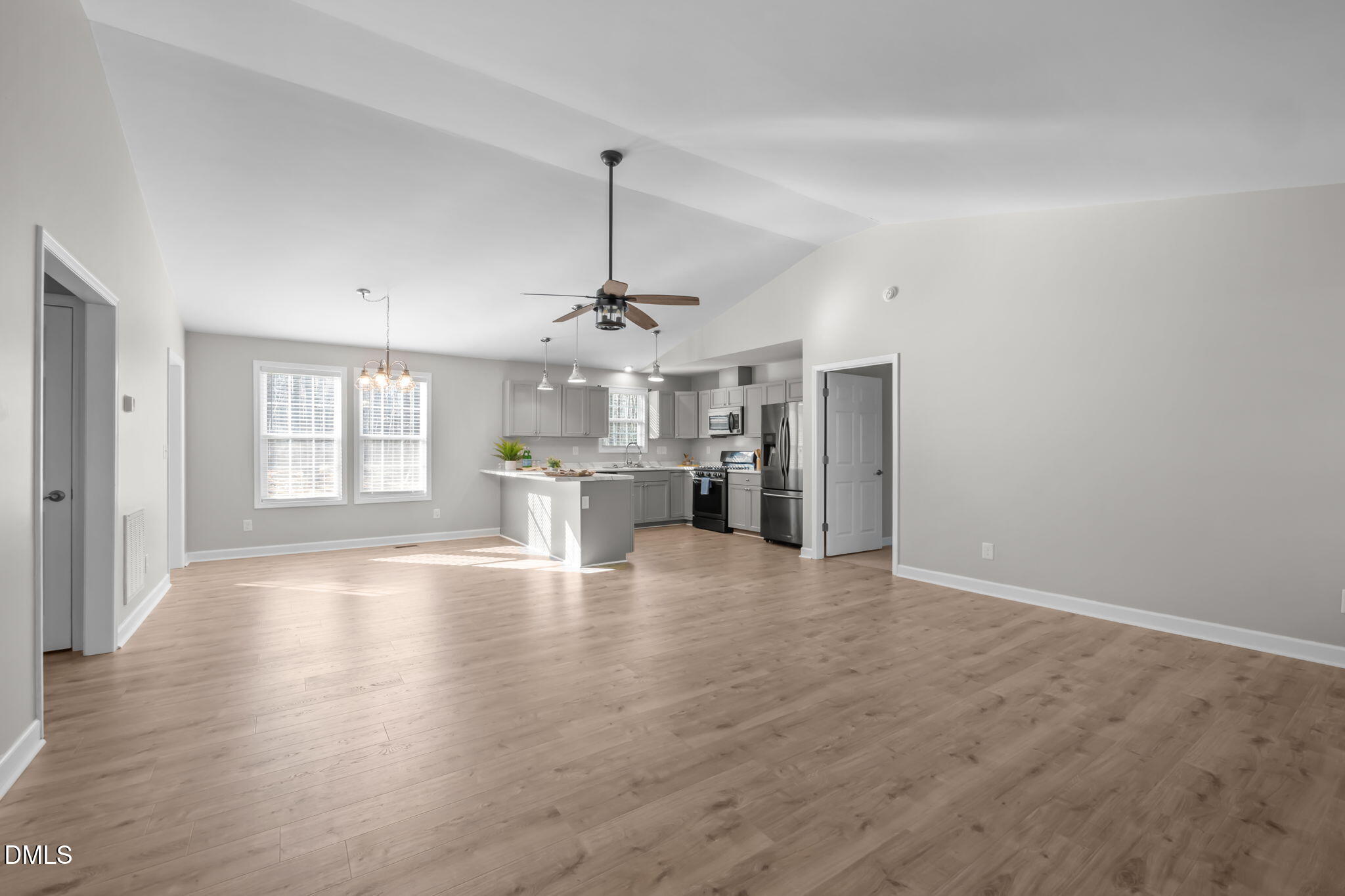 144 Kiser Hicks Road Roxboro, NC 27574 - Photo 2 of 38 a view of a kitchen with a sink dishwasher a refrigerator and wooden floor