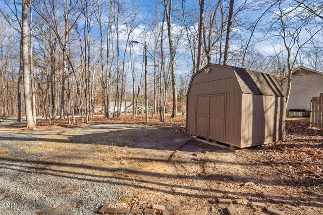 a view of a house with a yard covered with snow