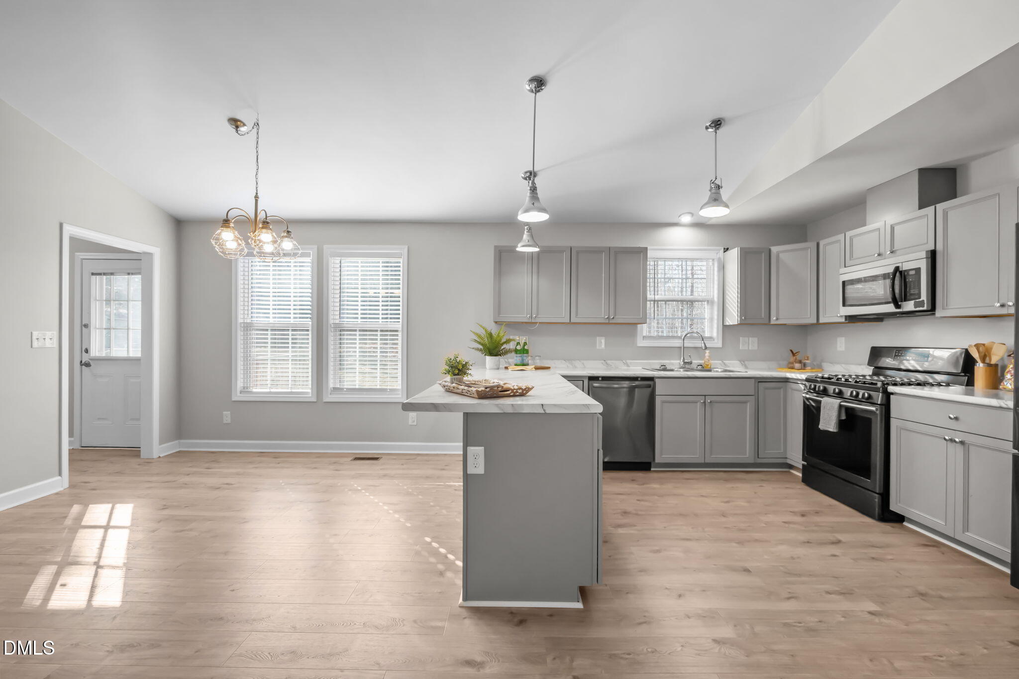 144 Kiser Hicks Road Roxboro, NC 27574 - Photo 5 of 38 a large kitchen with stainless steel appliances granite countertop a stove a sink dishwasher a refrigerator and a dining table with wooden floor