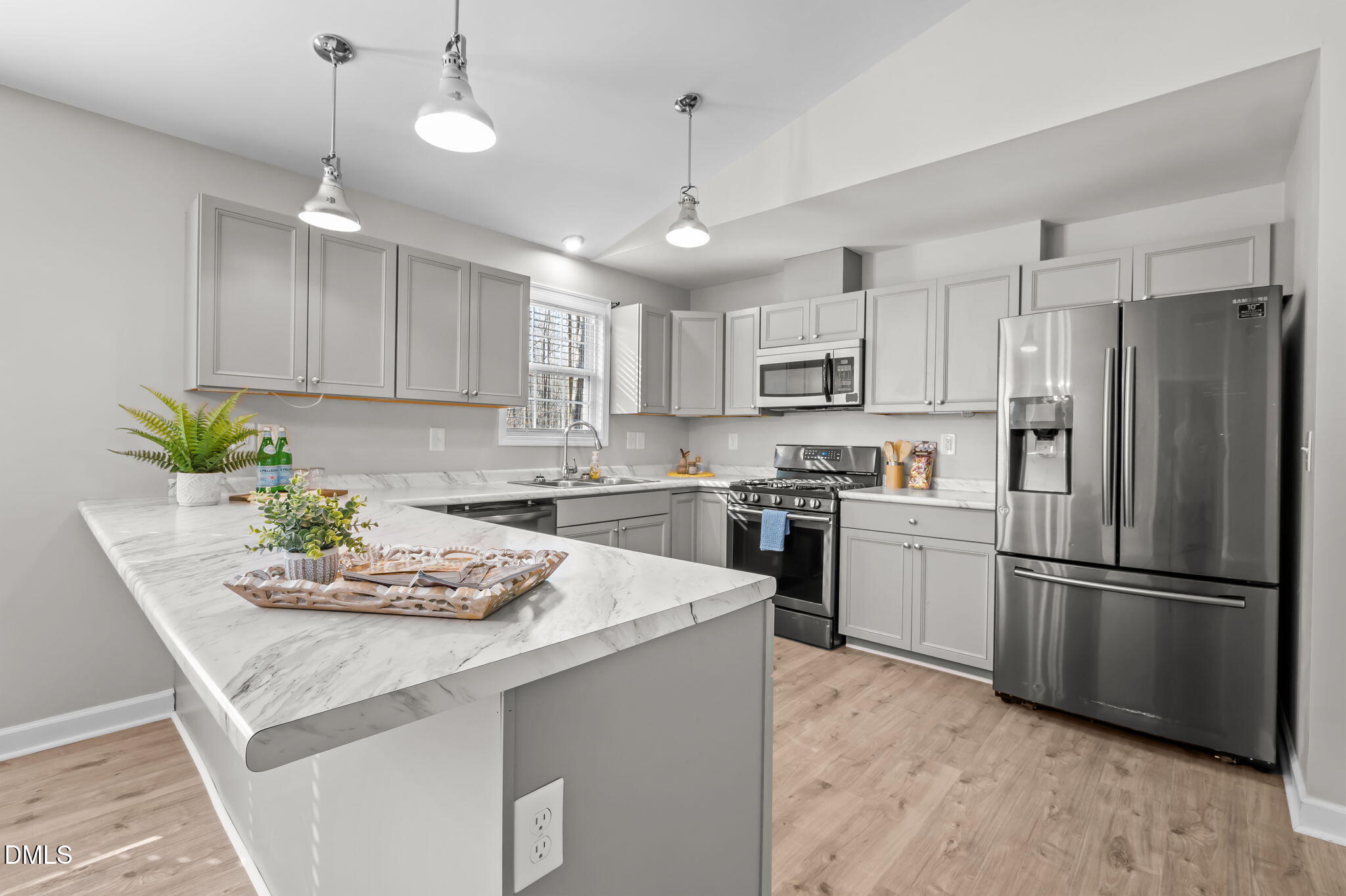 144 Kiser Hicks Road Roxboro, NC 27574 - Photo 6 of 38 a kitchen with refrigerator a sink and chairs