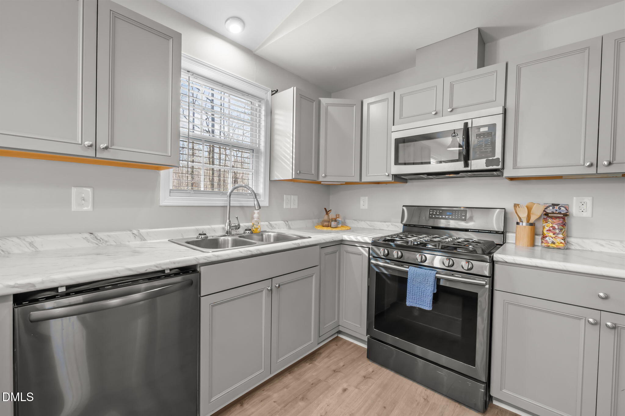 144 Kiser Hicks Road Roxboro, NC 27574 - Photo 8 of 38 a kitchen with stainless steel appliances granite countertop a sink stove oven and white cabinets