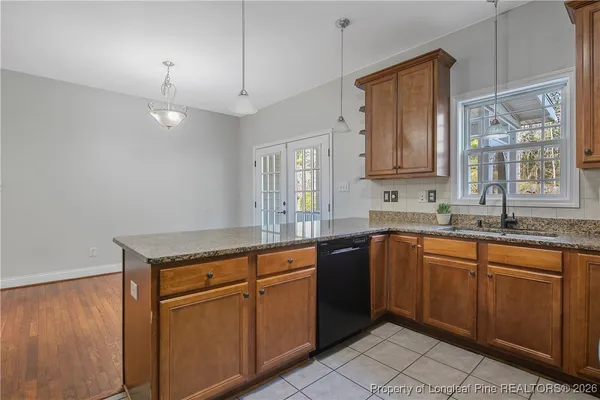 a kitchen with stainless steel appliances granite countertop a stove sink and cabinets