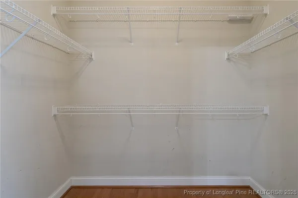 a view of a livingroom with wooden floor and staircase