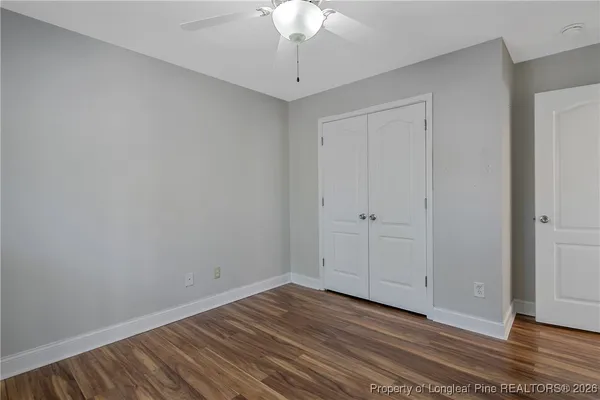 a view of an empty room with wooden floor