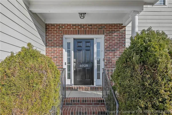 a view of a brick house with a door and wooden floor