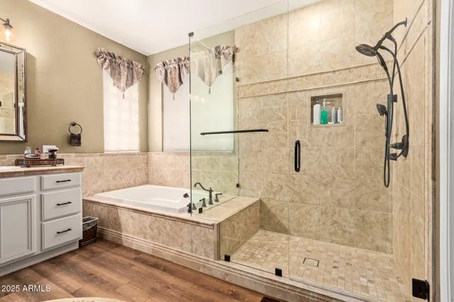 a bathroom with a double vanity sink mirror and shower