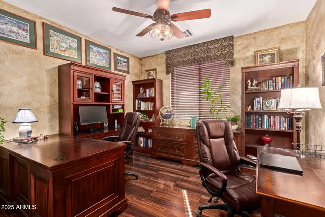 a view of a workspace with furniture and a bookshelf