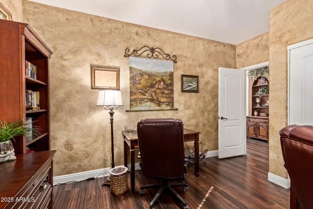 a view of a workspace with furniture and wooden floor