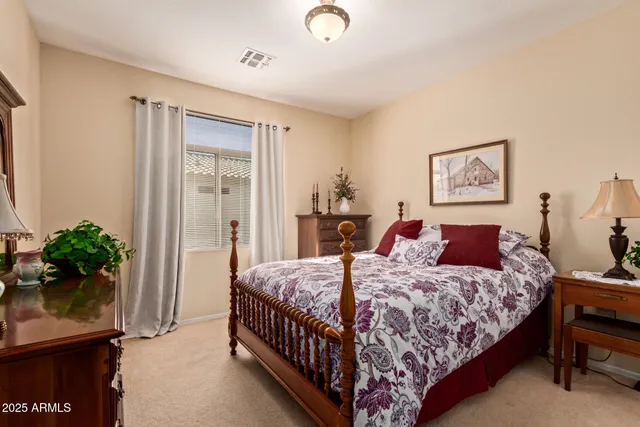a bedroom with a bed and potted plant