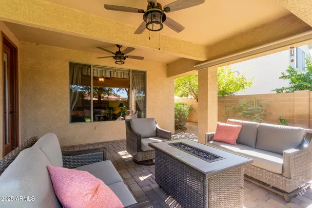 a living room with furniture a chandelier and a window
