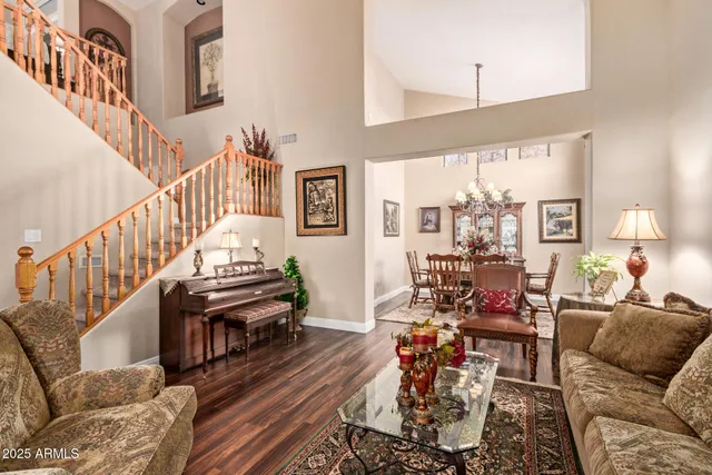 a living room with furniture and a chandelier