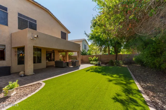 a view of a house with backyard porch and furniture