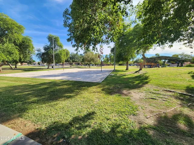a swimming pool with an outdoor space and seating area