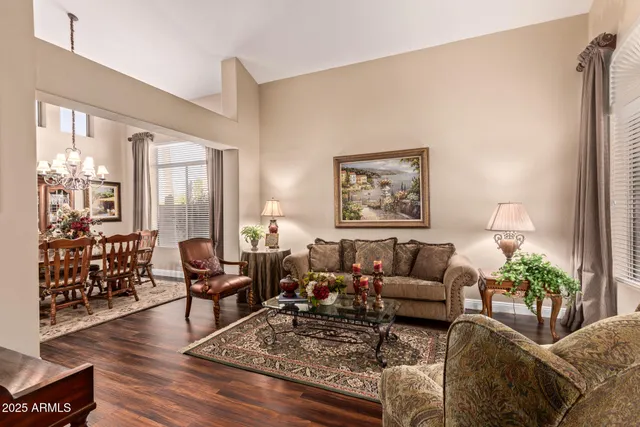 a living room with furniture couches and a large window