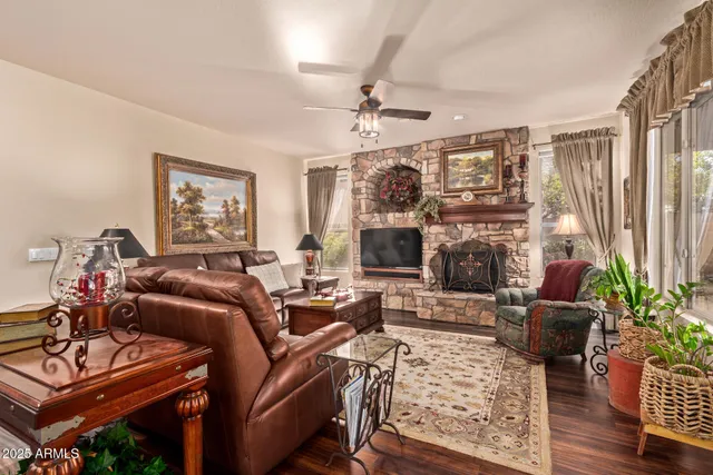 a living room with furniture a fireplace and a flat screen tv