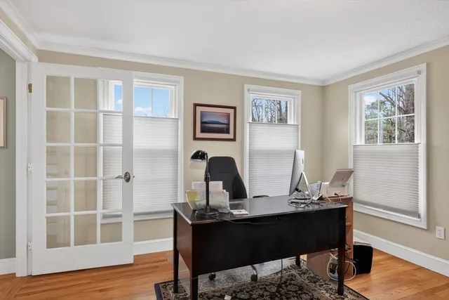 a view of a workspace with furniture and a window