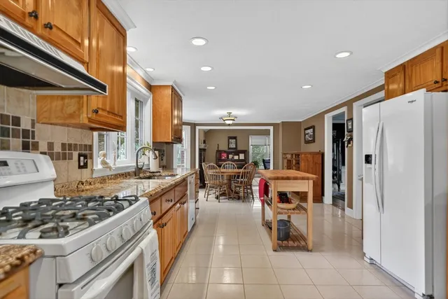 a kitchen with stainless steel appliances granite countertop a stove and a refrigerator