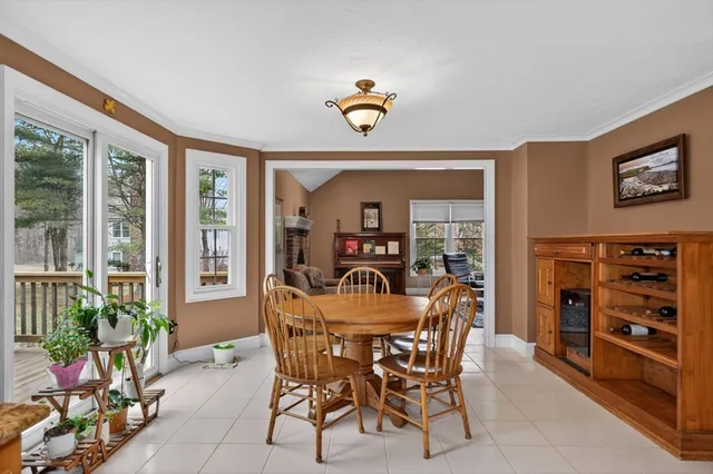 a view of a dining room with furniture and a potted plant